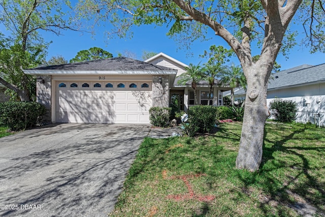 ranch-style home with an attached garage, concrete driveway, and a front lawn