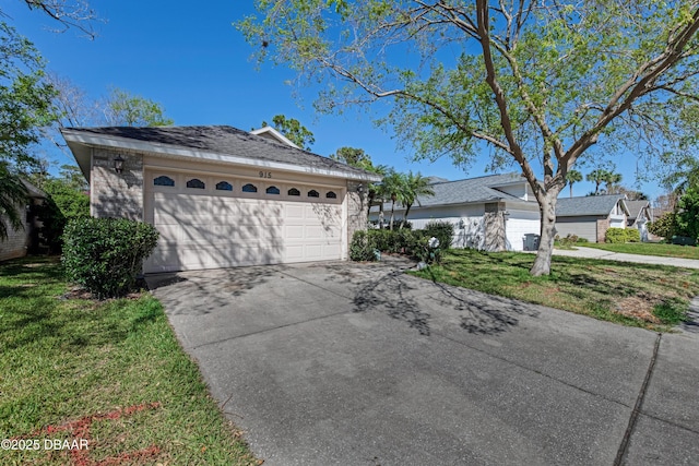 ranch-style house with an attached garage, concrete driveway, and a front yard