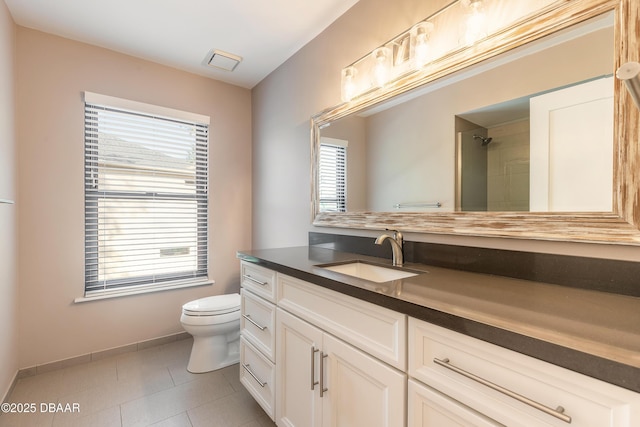 bathroom with vanity, toilet, and tile patterned floors