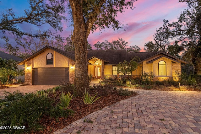 ranch-style home featuring a garage