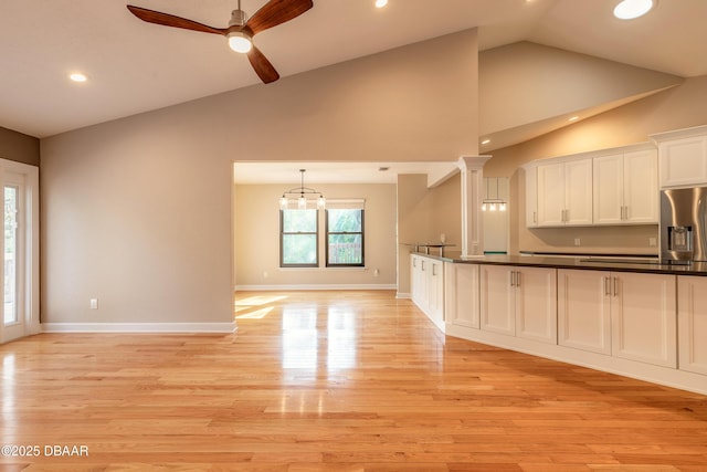 kitchen featuring white cabinetry, pendant lighting, stainless steel refrigerator with ice dispenser, and light hardwood / wood-style flooring