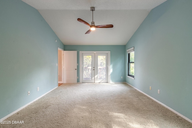 empty room with ceiling fan, carpet, a textured ceiling, and lofted ceiling