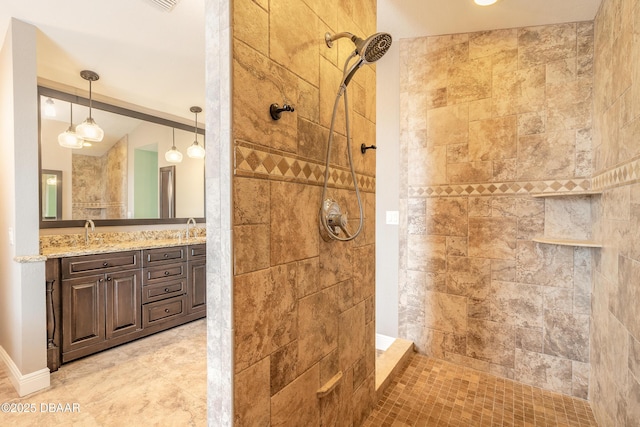 bathroom with vanity and tiled shower