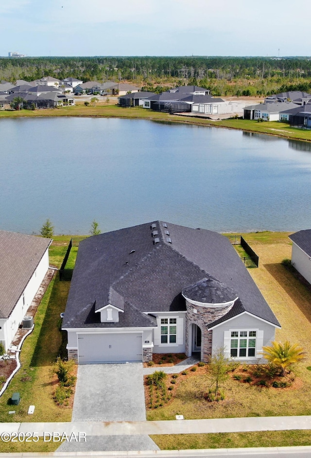 drone / aerial view featuring a residential view and a water view