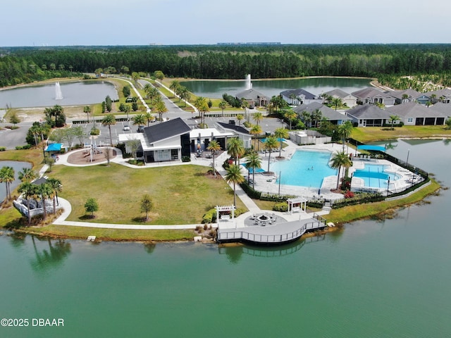 aerial view with a water view and a wooded view