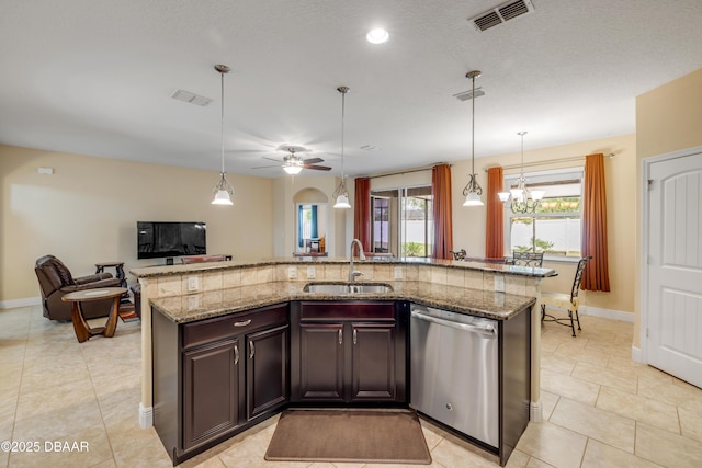 kitchen featuring a sink, open floor plan, visible vents, stainless steel dishwasher, and an island with sink