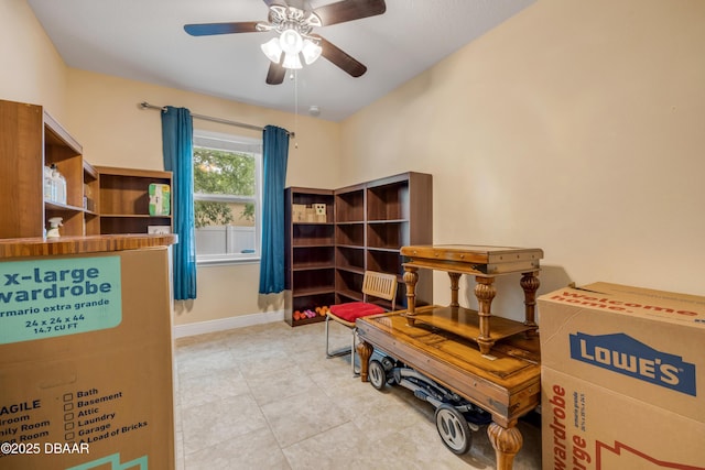 interior space with ceiling fan