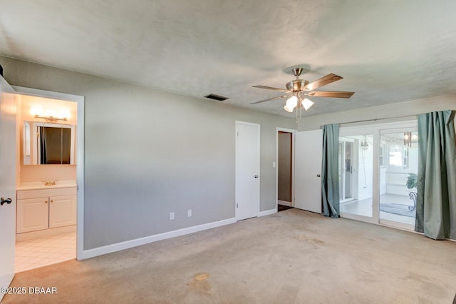 carpeted empty room with ceiling fan and sink