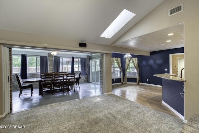 255 Woodhaven Cir W, Ormond Beach, FL 32174 - dining space featuring vaulted ceiling, a skylight, healthy amount of natural light, and a chandelier