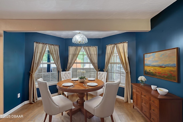 255 Woodhaven Cir W, Ormond Beach, FL 32174 - dining area with a chandelier and light wood-style floors