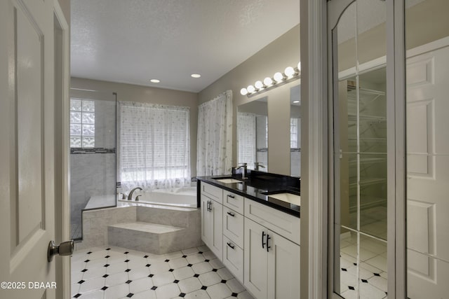 255 Woodhaven Cir W, Ormond Beach, FL 32174 - bathroom featuring a garden tub, double vanity, a spacious closet, and recessed lighting
