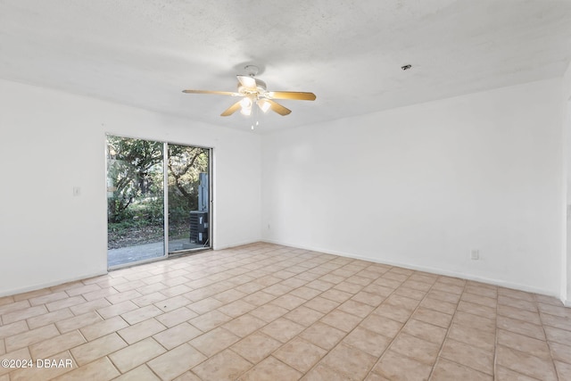 unfurnished room featuring ceiling fan, light tile patterned floors, and a textured ceiling