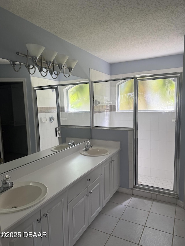 full bathroom featuring double vanity, tile patterned flooring, and a sink