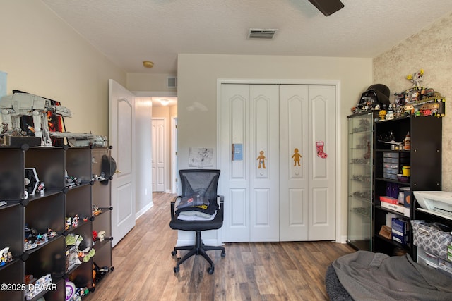 office area featuring wood-type flooring and a textured ceiling