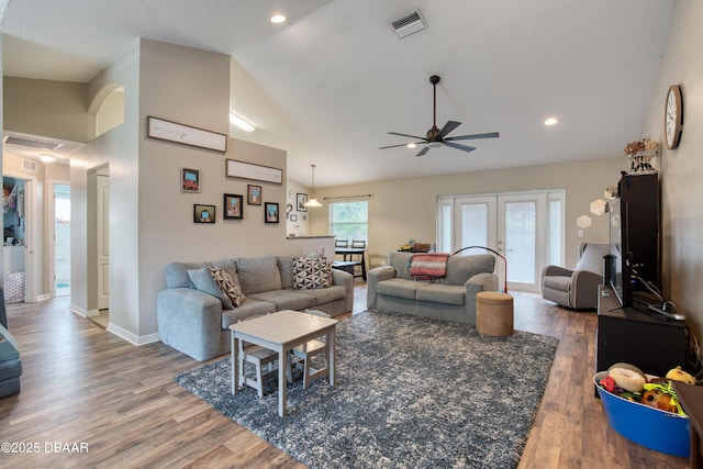 living room with hardwood / wood-style flooring, high vaulted ceiling, and ceiling fan