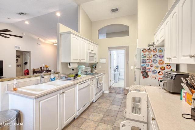 kitchen with white cabinetry, sink, ceiling fan, kitchen peninsula, and white appliances