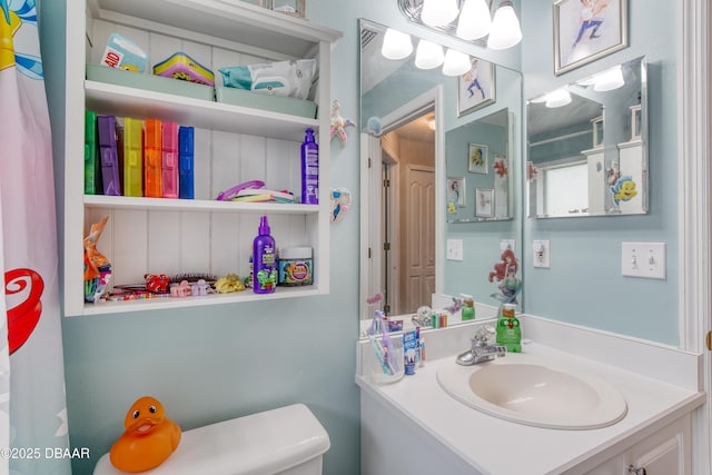 bathroom featuring vanity and toilet