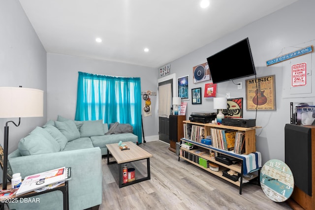 living room with recessed lighting, baseboards, and wood finished floors