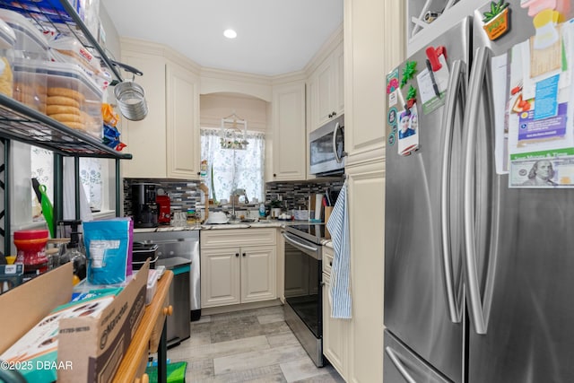 kitchen with tasteful backsplash, light wood-style flooring, light stone counters, stainless steel appliances, and a sink