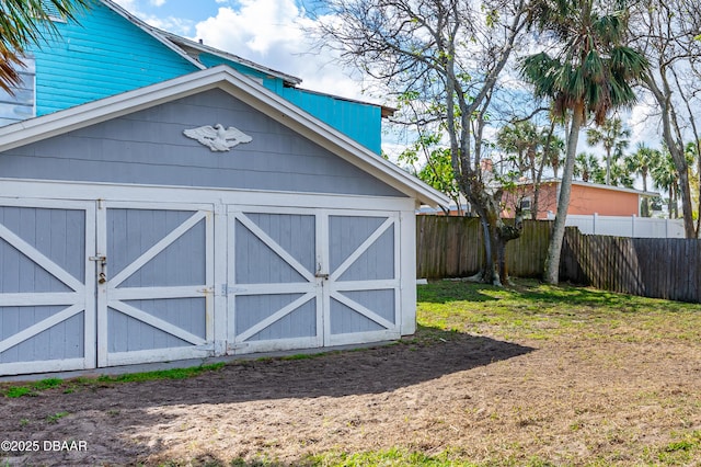 view of shed featuring fence