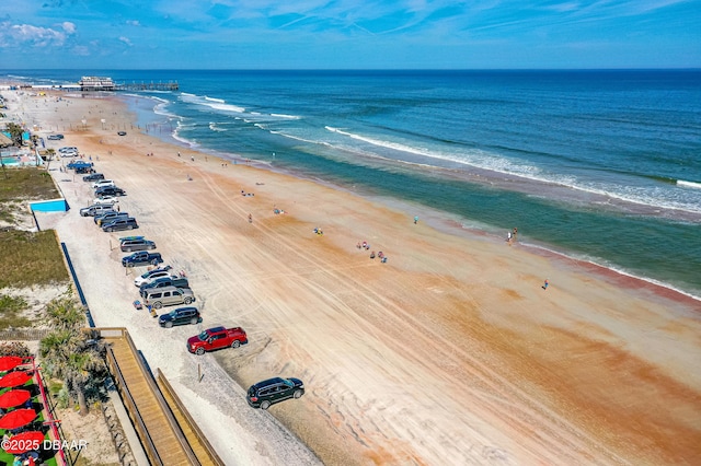 birds eye view of property featuring a water view and a beach view