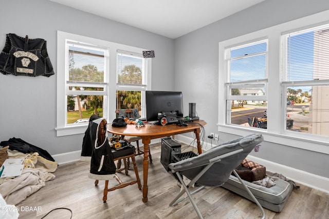 office area featuring light wood finished floors and baseboards