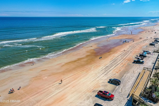 bird's eye view featuring a view of the beach and a water view