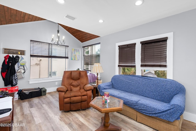 living area with recessed lighting, visible vents, an inviting chandelier, vaulted ceiling, and light wood-type flooring