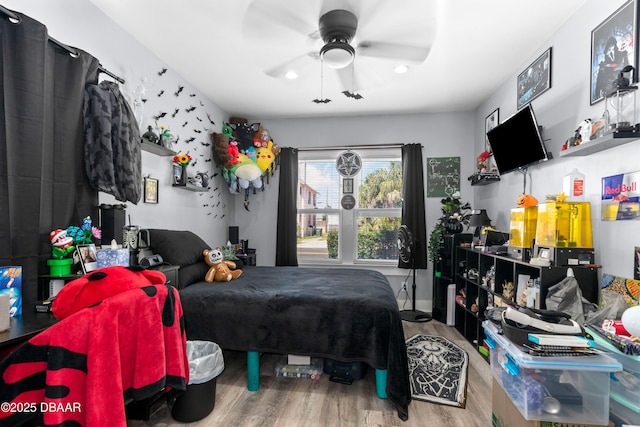 bedroom with a ceiling fan and wood finished floors