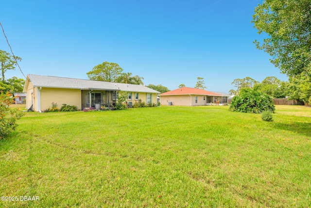 3035 Victory Palm Dr, Edgewater, FL 32141 - view of green lawn with a sunroom