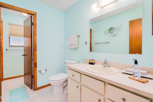 3035 Victory Palm Dr, Edgewater, FL 32141 - bathroom with tile patterned flooring, toilet, vanity, and baseboards