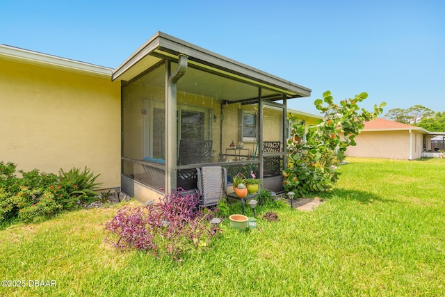 3035 Victory Palm Dr, Edgewater, FL 32141 - view of side of property with a sunroom, a yard, and stucco siding