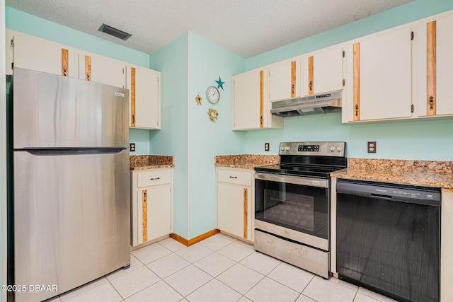 3035 Victory Palm Dr, Edgewater, FL 32141 - kitchen with stainless steel appliances, under cabinet range hood, white cabinets, light stone counters, and light tile patterned floors