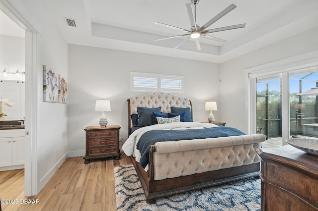 3236 Modena Way, New Smyrna Beach, FL 32168 - bedroom featuring a raised ceiling, access to exterior, light wood-style floors, and multiple windows