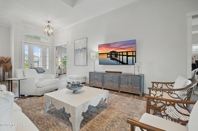 3236 Modena Way, New Smyrna Beach, FL 32168 - living room with ornamental molding, wood finished floors, and a chandelier