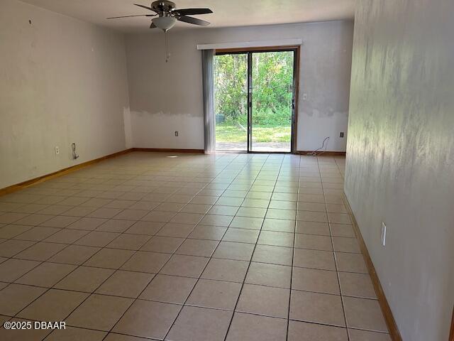 unfurnished room with light tile patterned flooring, baseboards, and ceiling fan