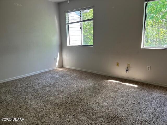 carpeted spare room with baseboards