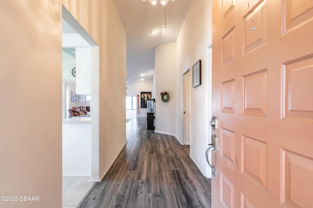 hall featuring dark wood finished floors and baseboards