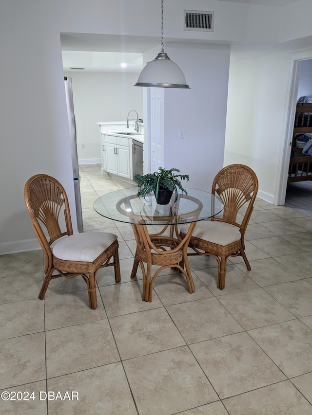 dining area featuring light tile patterned floors and sink