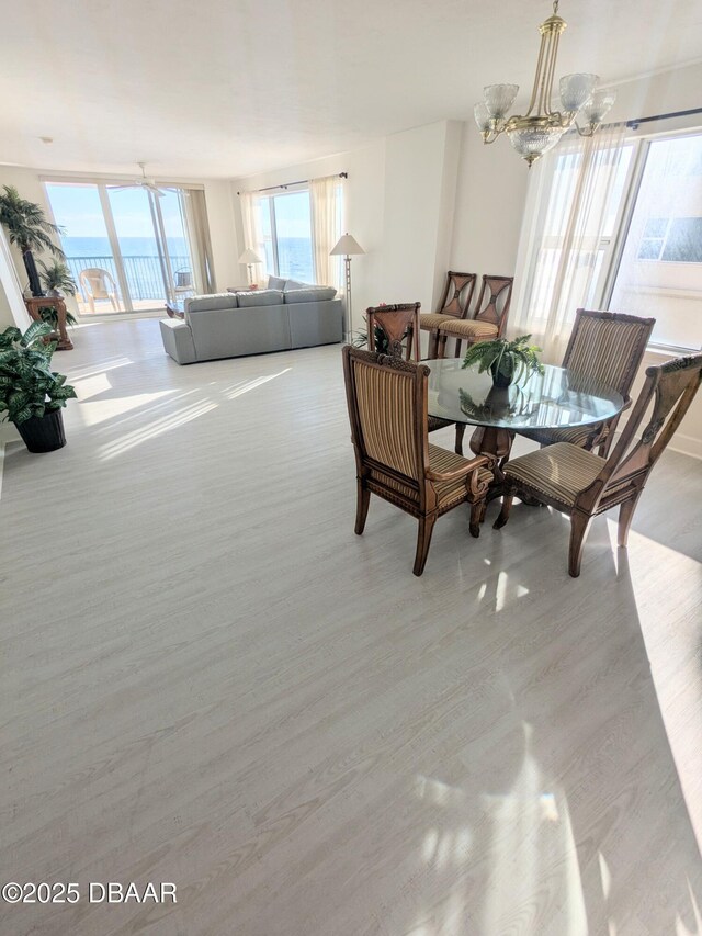 dining area with a notable chandelier and light hardwood / wood-style flooring