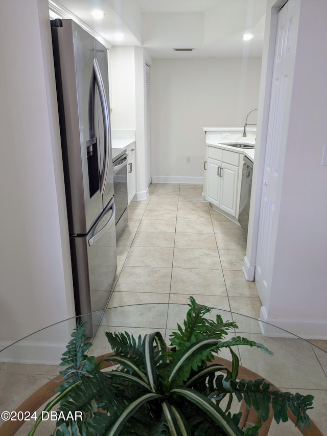 3311 S Atlantic Ave Unit 604, Daytona Beach, FL 32118 - kitchen with appliances with stainless steel finishes, light countertops, white cabinets, light tile patterned floors, and recessed lighting