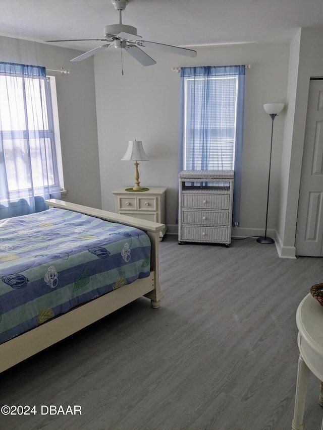 bedroom with ceiling fan and wood-type flooring