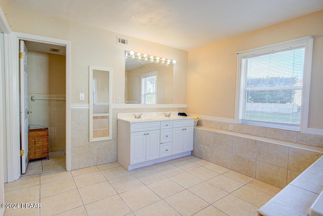 bathroom featuring tile patterned flooring, vanity, and tile walls