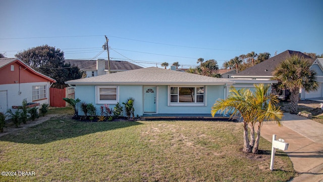 single story home featuring a front lawn