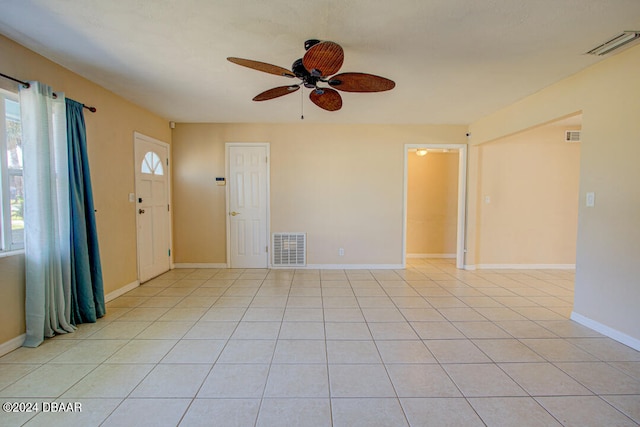 interior space with ceiling fan and light tile patterned flooring