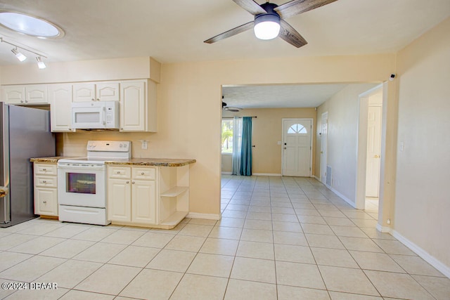 kitchen with ceiling fan, rail lighting, dark stone countertops, white appliances, and light tile patterned floors