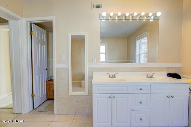 bathroom featuring tile patterned flooring and vanity