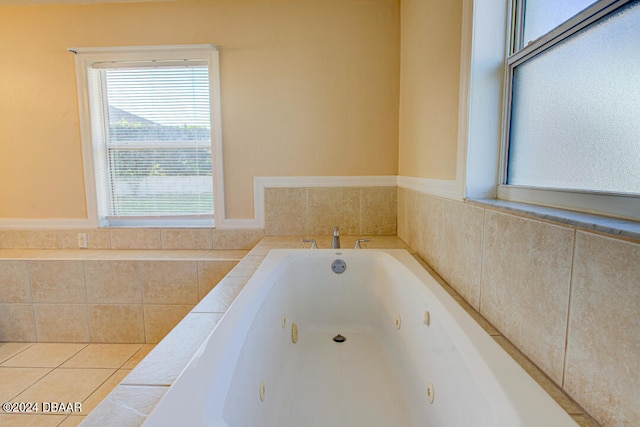bathroom with tile patterned floors and a relaxing tiled tub