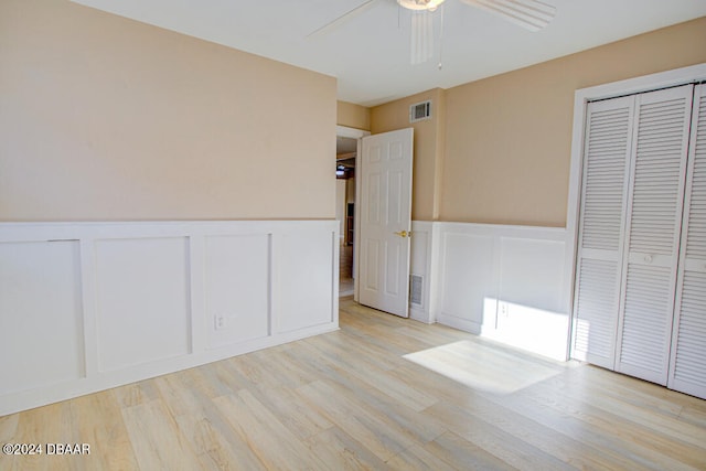unfurnished bedroom with ceiling fan and light hardwood / wood-style floors