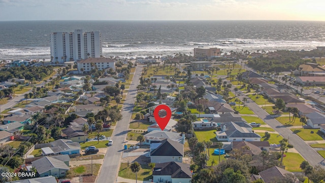 drone / aerial view with a water view and a view of the beach